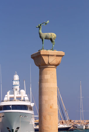 Bronze statue of a deer on a stone column in the harbor of Rhodes.の写真素材
