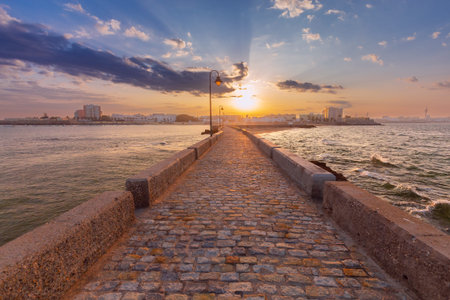 Breakwater bridge from Fort San Sebastian to the shore at dawn.