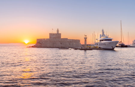 Old stone lighthouse in Fort St. Nicholas in Rhodes early in the morning.