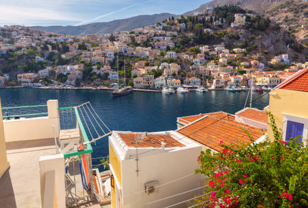 Multi-colored facades of houses in the Greek village Symi on a sunny day