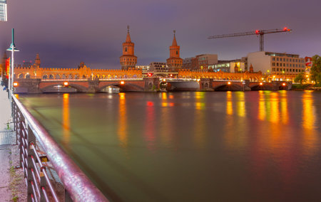 Old Berlin Oberbaum Bridge over the Spree River at sunset.