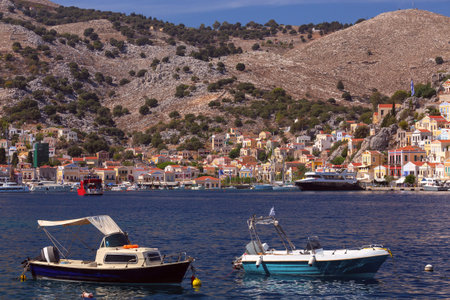 Bright colorful houses on the shore of the bay in the Greek fishing village Symi