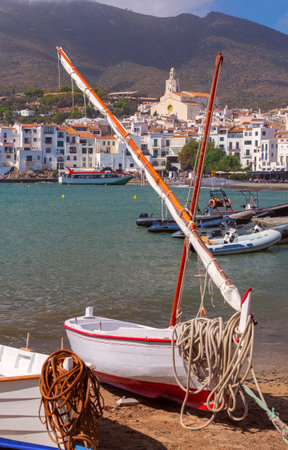Traditional Boat on the Shore in Cadaques, Spain with Coastal Viewの写真素材