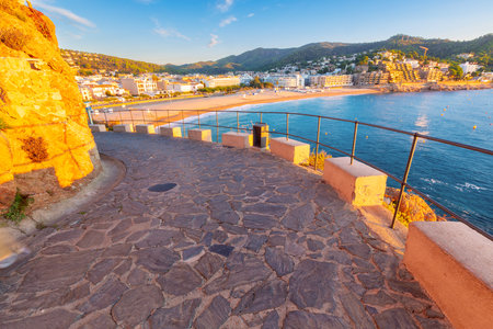 Stone path overlooking the coast at sunrise, Tossa de Mar, Spainの写真素材
