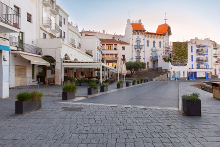 Old houses along the central city street of Cadaques on the shore.