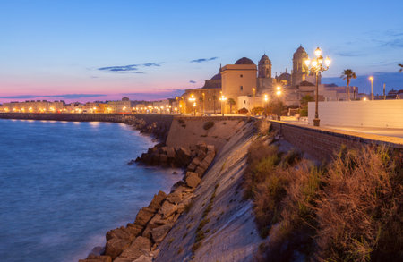 Cadiz Cathedral and Coastline at Dusk in Cadiz Spainの写真素材