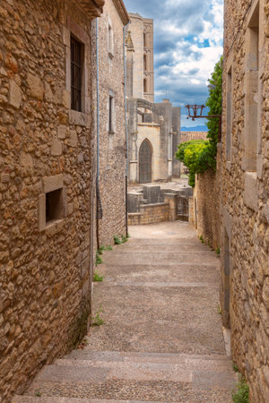 Gothic church and old stone alley in Girona Spainの写真素材