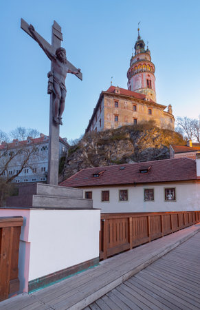 Tower and crucifix at sunrise, Cesky Krumlov, Czech Republicの写真素材
