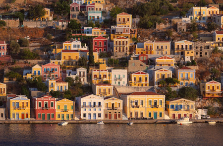 Sunset Light Over Colorful Waterfront Houses in Symi Greece