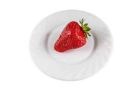 Healthy food. Strawberries on plate isolated on white backgroundの写真素材