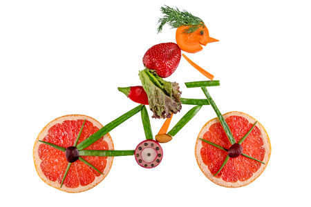 Healthy food. Figure bicycle made of fresh vegetables and fruits full of vitamins, isolated on white.の写真素材