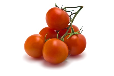 sprig of of ripe, juicy cherry tomatoes on a white backgroundの写真素材