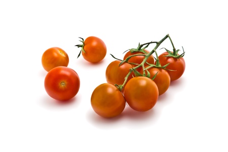 sprig of of ripe, juicy cherry tomatoes on a white backgroundの写真素材