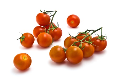 sprig of of ripe, juicy cherry tomatoes on a white backgroundの写真素材
