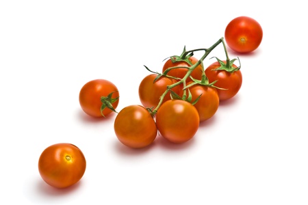 sprig of of ripe, juicy cherry tomatoes on a white backgroundの写真素材