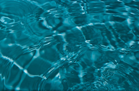Circles, ripples and reflections of light on the clear water