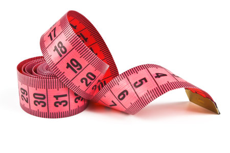 pink tape measure twisted spiral on white background