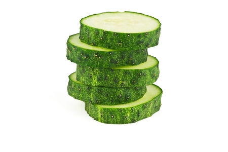 Slices of cucumber in the form of uneven pillar on a white backgroundの写真素材