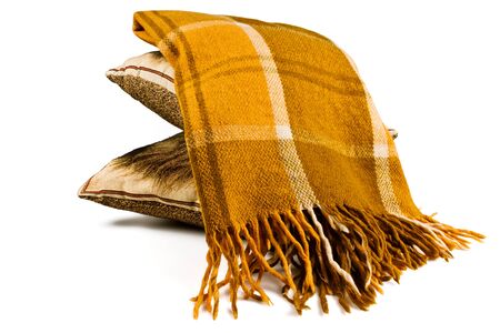 Yellow brown plaid blanket with geometric pattern and fringe on a white backgroundの写真素材