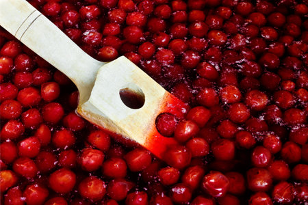 Wooden spoon for stirring when cooking cherry jam