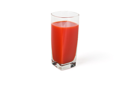 High Transparent glass cup of tomato juice on a white backgroundの写真素材