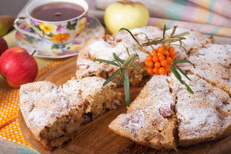 Apple pie, cup of tea, apple, pear and sea buckthorn branchの写真素材