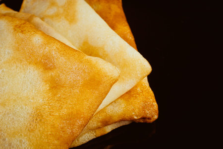 Fresh pancakes golden brown but black background