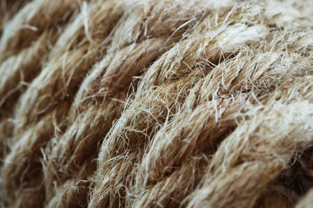 Twisted braided hemp rope close-up on a dark backgroundの写真素材