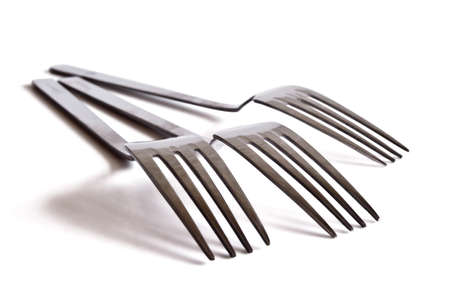 Three stainless steel fork on a white backgroundの写真素材