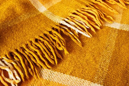 Warm cozy checkered brown wool plaid with fringeの写真素材