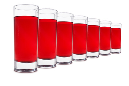A number of glasses with cherry juice isolated on white backgroundの写真素材