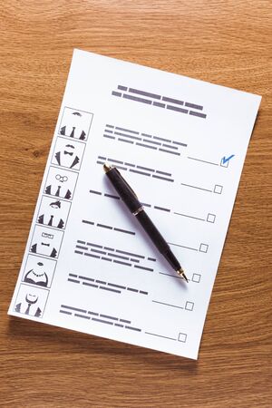 Election of the presidential candidate. Presidential elections. List of selections, put a tick, pen, pencil on wooden backgroundの写真素材