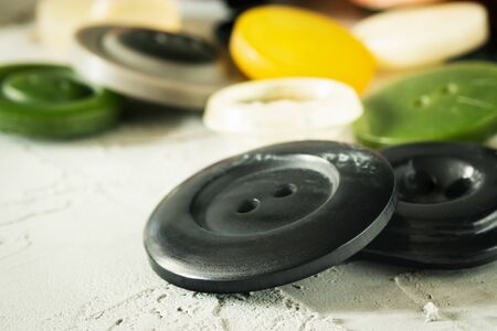 Buttons different in size, size and color on a gray concrete backgroundの写真素材
