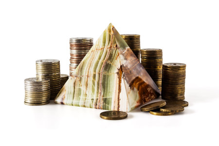 Pyramid and stacks of coins isolated on white backgroundの写真素材
