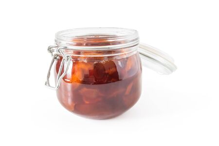 Jam from apple slices in a glass jar close-up isolated on a white backgroundの写真素材