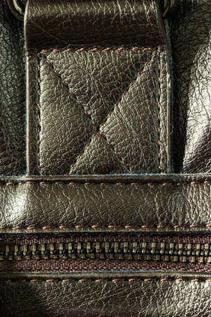 Close-up of a zip fastener with a lock on a leather productの写真素材