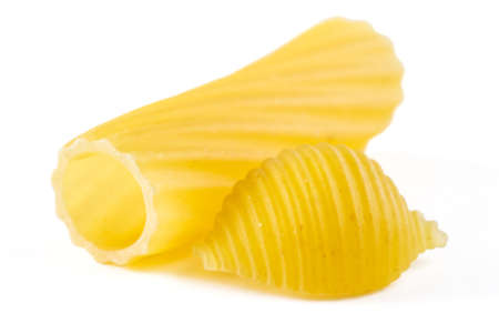 Tubular pasta with swirling wavy surface and shells isolated on white backgroundの写真素材