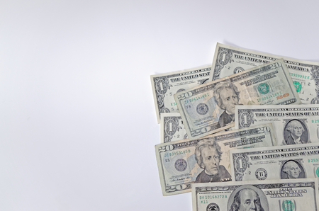 American dollars are laid out on white backgroundの写真素材