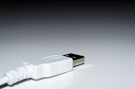 White USB cable connector on white backgroundの写真素材