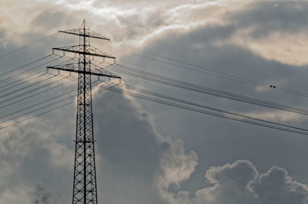 Scenery of high voltage tower and dramatic cloudy sky as a backgroundの写真素材