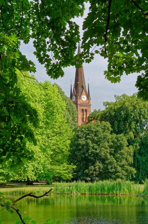 Looking through trees on a small chapel from Johannapark (Clara-Zetkin-Park), Leipzig, Germanyの写真素材