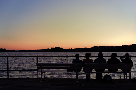 Romantic scene of sunset watching on the lake coastの写真素材