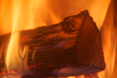 Close-up photo of single log in yellow red fire flamesの写真素材