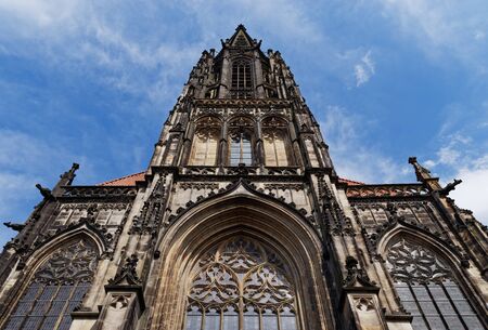 Front facade of St Lambert's Church against blue sky. Muenster, Germanyの写真素材
