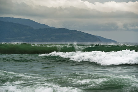 Stormy sea view near coastline at evening. Waves and splashed drops.Da nang beach, Vietnam