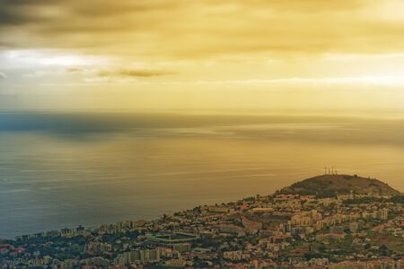 Beautiful golden sky over the coastline on Portuguese island of Madeiraの写真素材