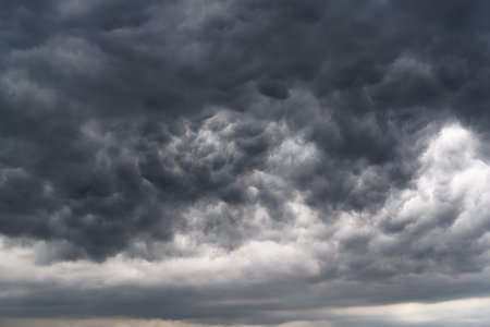 Low angle view of dramatic sky and dark stormy clouds