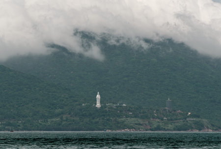 Clouds rolling over the mountain range and Linh Ung pagoda of Son Tra Peninsula. Da Nang in Central...