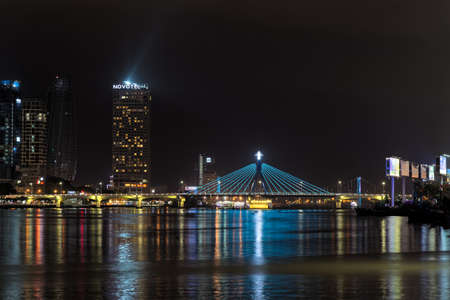 Da Nang, Vietnam - May 11, 2019: Illuminated skyscrapers and Han river bridge at nightのeditorial素材