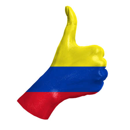 Hand with thumb up paint in colors of Colombia national flag isolated on white background. Symbol of like excellence, achievement, - for tourism, political, social management, sports, championshipの写真素材